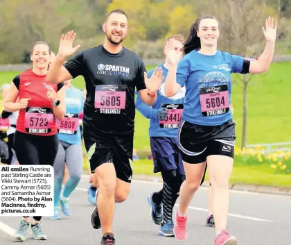  ??  ?? All smiles Running past Stirling Castle are Vikki Stewart (5723), Cammy Asmar (5605) and Samantha Asmar (5604).