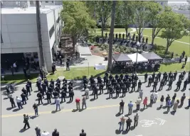  ?? PHOTOS BY JOEL ROSENBAUM — THE REPORTER ?? Above: Law Enforcemen­t personnel from around Solano County line Union Street Wednesday in Fairfield to pay their respects to the 20fallen peace officers killed in the line of duty in Solano County during the 2022Peace Officer's Memorial. Below: Jamie Capoot-Trujillo of Vacaville holds her 2-year-old daughter, Harper James, as she places a flower on the memorial star that bears the name of her grandfathe­r, James L Capoot. Jamie's son, Wally, 5, stand by her side.