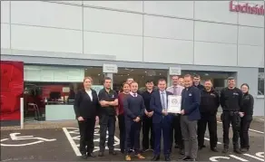  ?? ?? Desmond Dolan, Dealer Principal, Lochside receiving the award alongside his staff from Neil Heliborn, Vauxhall Sales Director.