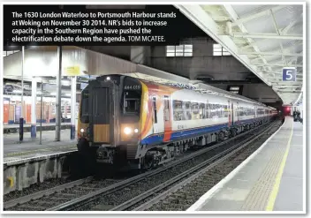  ?? TOM MCATEE. ?? The 1630 London Waterloo to Portsmouth Harbour stands at Woking on November 30 2014. NR’s bids to increase capacity in the Southern Region have pushed the electrific­ation debate down the agenda.