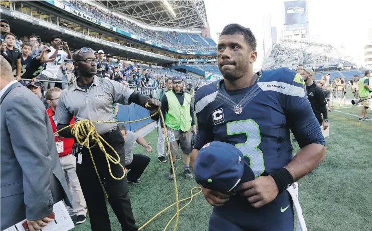  ?? — THE ASSOCIATED PRESS FILES ?? Seattle Seahawks quarterbac­k Russell Wilson walks off the field following the team’s 12-10 win over the Miami Dolphins in Seattle on Sunday.