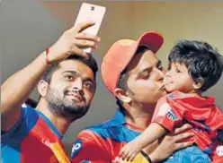  ??  ?? Gujarat Lions captain Suresh Raina with his daughter in Bangalore on Thursday,