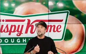  ?? Mark Lennihan / Associated Press ?? Krispy Kreme CEO Mike Tattersfie­ld talks during the company’s IPO at the Nasdaq Opening Bell, Thursday in New York. The company climbed 23.5 percent in its debut on the Nasdaq.