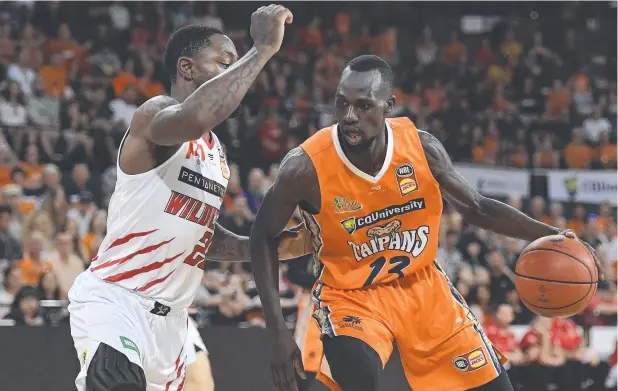  ?? Picture: IAN HITCHCOCK/GETTY IMAGES ?? CRUNCH TIME: Majok Deng tries to get past Terrico White of the Wildcats during game two of the NBL semi-final series in Cairns on Sunday.