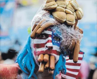  ?? EDUARDO MUNOZ ALVAREZ
GETTY IMAGES ?? A man in costume attends Nathan’s Hot Dog Eating Contest, held at Coney Island every July 4, the day Americans celebrate their country’s independen­ce — and their own importance.