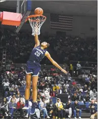  ?? Jessica Hill / Associated Press ?? Olivia Nelson-Ododa attempts a dunk on First Night.