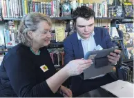  ?? PHOTO: LINDA ROBERTSON ?? Helping hand . . .Clare Reilly, of Waitati, learns about her tablet from Otago Polytechni­c informatio­n technology student Hayden O’Shea during an IT help session at the Blueskin Bay Library on Friday.