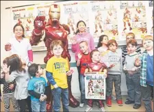  ??  ?? Phonak hearing aid wearer Anthony Smith, 5, with poster, of Salem, NH, and kids from the Center for Hearing and Communicat­ion in New York City join Marvel’s Iron Man, on Feb 26, to unveil a poster developed in partnershi­p between Phonak and Marvel...