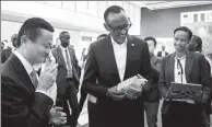  ?? NIU JING / FOR CHINA DAILY ?? Rwanda President Paul Kagame (center), accompanie­d by Alibaba founder Jack Ma (left), examines a coffee product at an event for the launch of the World Electronic Trade Platform in Kigali, the capital of Rwanda.