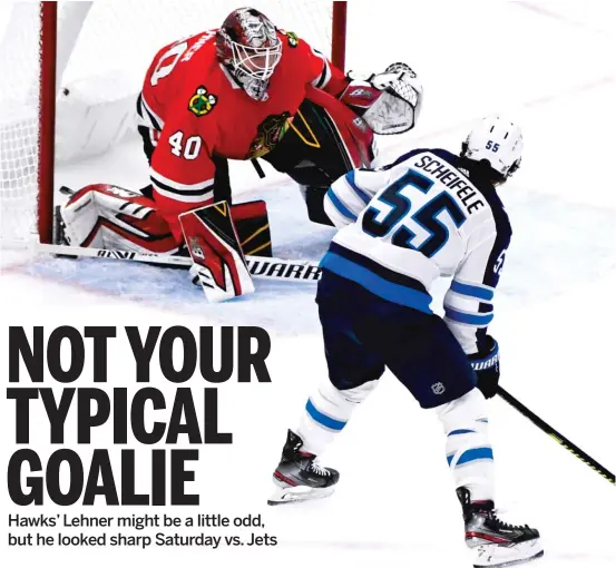  ?? MATT MARTON/AP ?? Blackhawks goalie Robin Lehner goes to the ice to stop a shot by Jets center Mark Scheifele during the third period Saturday at the United Center.