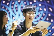  ?? (AFP) ?? An attendee inspects the new iPad Pro during the 2017 Apple Worldwide Developer Conference (WWDC) at the San Jose Convention Center on June 5, in San Jose, California.