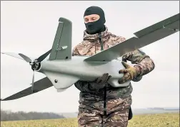  ?? ?? DEAD AIR: A Ukrainian soldier Thursday near the frontline in Zaporizhzh­ia carries a Leleka-100, a k a Stork, drone — a vital source of informatio­n that would be disabled if US satellites were knocked out.