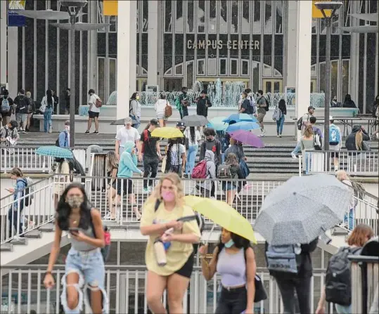  ?? Paul Buckowski / Times Union ?? Students at the University at Albany walk through the uptown campus on the first day of classes on Monday in Albany.