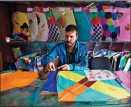  ?? WAKIL KOHSAR / AFP ?? An Afghan kite vendor cuts tissue paper as he makes a kite in a shop in Shor Bazaar in Kabul, on April 16.