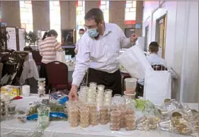  ?? Pam Panchak/Post-Gazette ?? Rabbi Yisroel Altein packs a Seder kit for members of Chabad of Squirrel Hill on Thursday ahead of Passover, which begins Saturday at sundown.