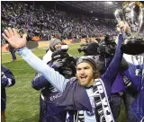  ??  ?? Sporting KC’s Graham Zusi celebrates with theMLS Cup after defeating Real Salt Lake in December. He’s one of the younger players likely to dominate the U.S. World Cup team.