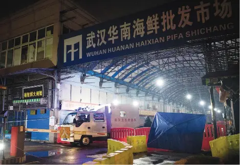  ?? Picture: AFP ?? EPICENTRE.
The Wuhan Hygiene Emergency Response Team leaves the closed Huanan Seafood Wholesale Market in the city of Wuhan, in China’s Hubei province on 11 January last year after the first death from what came to be known as Covid-19.