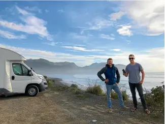  ??  ?? CamperMate’s Adam Hutchinson, left, with freedom camper Hans Grohe who donated $5 to stay at a campsite.