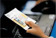  ?? ERIC GAY/AP 2014 ?? An official checks a voter’s photo ID at a polling site in Austin, Texas. A federal appeals court has ruled that Texas’ law discrimina­tes against minorities and the poor.