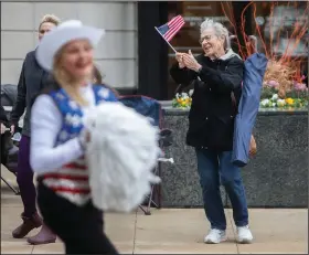  ?? (AP/Kenny Yoo) ?? A woman cheers as a member of the Milwaukee Dancing Grannies marches by.
