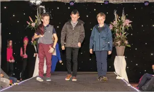  ?? ALL PICTURES JOHN DELEA. ?? West Muskerry AC members, Sean, Conor &amp; Jamie strut the runway with the latest styles from TM Cronin, Macroom, at the recent West Muskerry AC Fashion Show held in the Riverside Park Hotel.