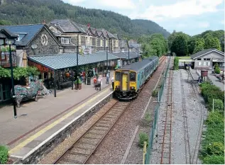  ?? DAVE TOZER ?? The classic view of Betws-y-Coed station from the footbridge on June 30 as No. 150279 calls with the 11.37 Blaenau Ffestiniog to Llandudno. Alongside is the Conwy Valley Railway Museum, which is built on the site of the former down platform and loop, the station’s surviving platform still being labelled Platform 2.