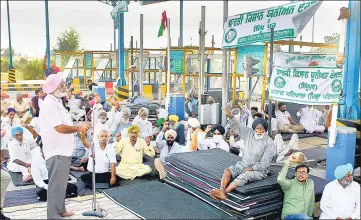  ?? PTI ?? Members of various farmers’ outfits block the National Highway toll gate during their 'chakka jam' protest against the new farm laws, near Rajpura in Patiala on Saturday
