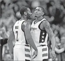  ?? [NICK WASS/THE ASSOCIATED PRESS] ?? Washington Wizards guards John Wall, left, and Bradley Beal chest-bump during the second half in Game 5 of the team’s first-round playoff series against the Atlanta Hawks on Wednesday in Washington. The Wizards won 103-99.