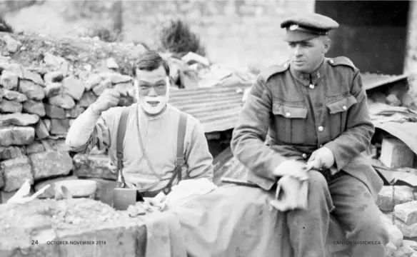  ??  ?? 24Below: A Japanese-Canadian soldier, left, shaves outside a dugout during an advance east of Arras, France, in September 1918.