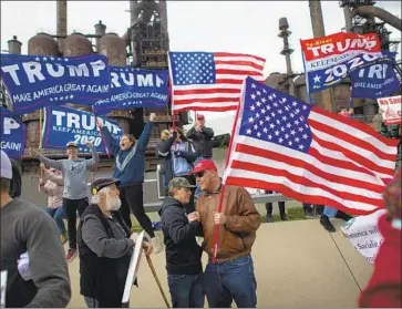  ?? Mark Makela Getty Images ?? SUPPORTERS of President Trump rally in Bethlehem, Pa., last month. Trump’s campaign team is trying to keep the president’s focus on positive economic news. Pennsylvan­ia’s jobless rate is the lowest since 1976.