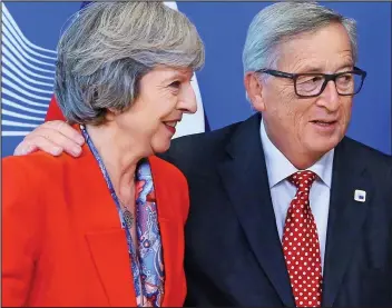  ??  ?? Hands on: Jean-Claude Juncker puts his arm around Theresa May’s shoulders yesterday