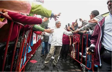  ?? — AFP ?? Man of the people: Lopez Obrador greeting supporters after a campaign rally in Tlaxcala, Mexico, in this file picture.