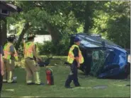  ?? KEVIN MARTIN — THE MORNING JOURNAL ?? Amherst firefighte­rs investigat­e the scene of a rollover crash in the 7000 block of West Ridge Road that sent a 37-year-old North Ridgeville man to hospital.