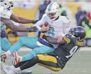  ?? CHARLES TRAINOR JR/MIAMI HERALD VIA THE ASSOCIATED PRESS ?? Dolphins QB Matt Moore missed just one play after getting hit in the helmet during Miami’s AFC wild-card playoff game against Pittsburgh this year.