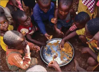  ??  ?? Children at the Gbajimba LG camp eating the ready-to-eat Jollof Rice and Spaghetti