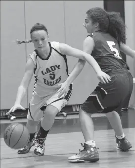  ??  ?? Oakwood Christian senior Tori Hall dribbles down the baseline past a Knoxville Christian defender during Friday’s home game. (Messenger photo/Scott Herpst)