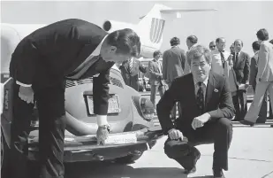  ?? HARRITY/ASSOCIATED PRESS FILE PHOTO ?? Republican presidenti­al candidate Ronald Reagan admires the bumper sticker on the car of Rep. Pete McCloskey as the congressma­n looks on, right, on Sept. 25, 1980, in San Jose, Calif.