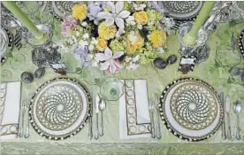  ??  ?? Timothy Corrigan created a table setting to celebrate French gardens anchored by a pair of Post’s 1909 silver candelabra by Tiffany. The green damask tablecloth (of Chateau Silk Damask, designed by Corrigan for Schumacher) sets off china of his own...