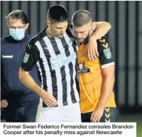  ??  ?? Former Swan Federico Fernandez consoles Brandon Cooper after his penalty miss against Newcastle
