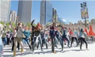  ??  ?? A flash mob in Chicago dances to “Wake Me Up,” the hit song narrator Blacc recorded with Avicii.