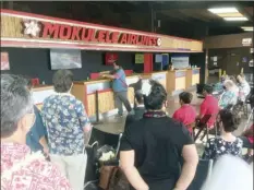  ??  ?? A small group gathers for a blessing of the newly renovated Kahului Commuter Terminal on Monday.