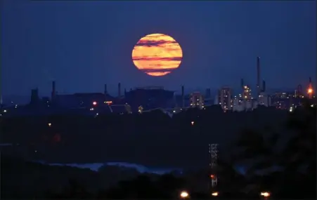  ??  ?? Spectator photograph­er Barry Gray captures an eye-popping harvest moon hovering over Hamilton Thursday, just one example of a natural beauty that we too often take for granted, and for which we should feel gratitude.