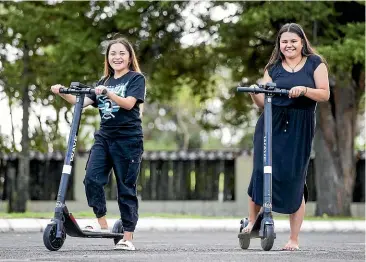  ?? JASON DORDAY/STUFF ?? Porshia Ihaka and Natasha Fleming-Potini testing out Wave e-scooters at the firm’s launch in Auckland yesterday.