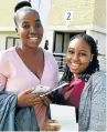  ?? Picture: EUGENE COETZEE ?? FIRST DAY DELIGHT: Nelson Mandela University first year students Vuyolwethu Nkomombini, 19, left, and Busisiwe Sibisi, 20, were welcomed into the institutio­n by vice chancellor Sibongile Muthwa with a ceremony held at the indoor sports centre on Saturday