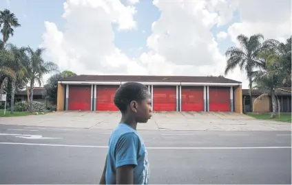  ?? Picture: Jacques Nelles ?? HOUSE OF BLUES. A boy walks past the Phillip-Nel Fire Station in Pretoria yesterday.