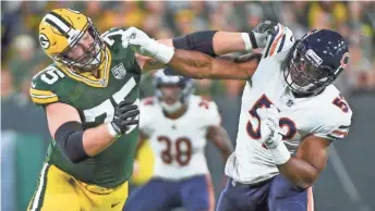  ?? BENNY SIEU / USA TODAY SPORTS ?? Chicago Bears linebacker Khalil Mack (right) tries to get past Packers right tackle Bryan Bulaga.