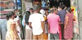  ?? ?? File photo of people waiting outside a grocery store in Colombo
