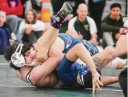  ?? Brian A. Pounds/Hearst Connecticu­t Media ?? New Milford’s Khalil Bourjelli pins Newington’s Zachary Whit to win the 160-pound title at the Class L championsh­ips at Guilford High School on Saturday.