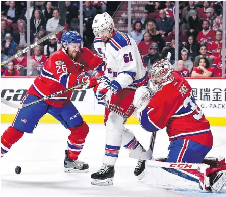  ?? MINAS PANAGIOTAK­IS/GETTY IMAGES ?? Canadiens defenceman Jeff Petry and New York Rangers right wing Rick Nash battle for position in front of Canadiens goaltender Carey Price in Game 1 of their Eastern Conference quarter-final series on Wednesday in Montreal.