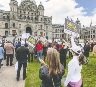  ?? DARREN STONE/TIMES COLONIST ?? People gather on the lawn of the Legislatur­e on Thursday, World Family Doctor Day, to demand immediate government funding to shore up the province's crumbling health-care system.